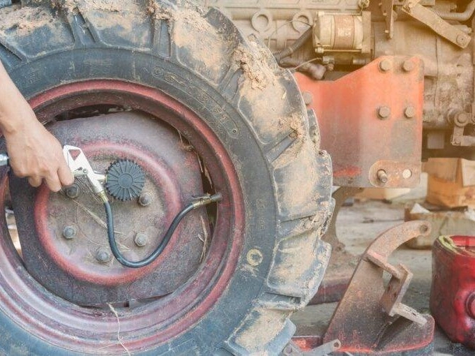 compact wheel loader tire inspection stubble field farm